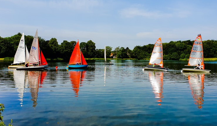 View of boats on the water in sunshine at Himley Hall SC, Midlands.