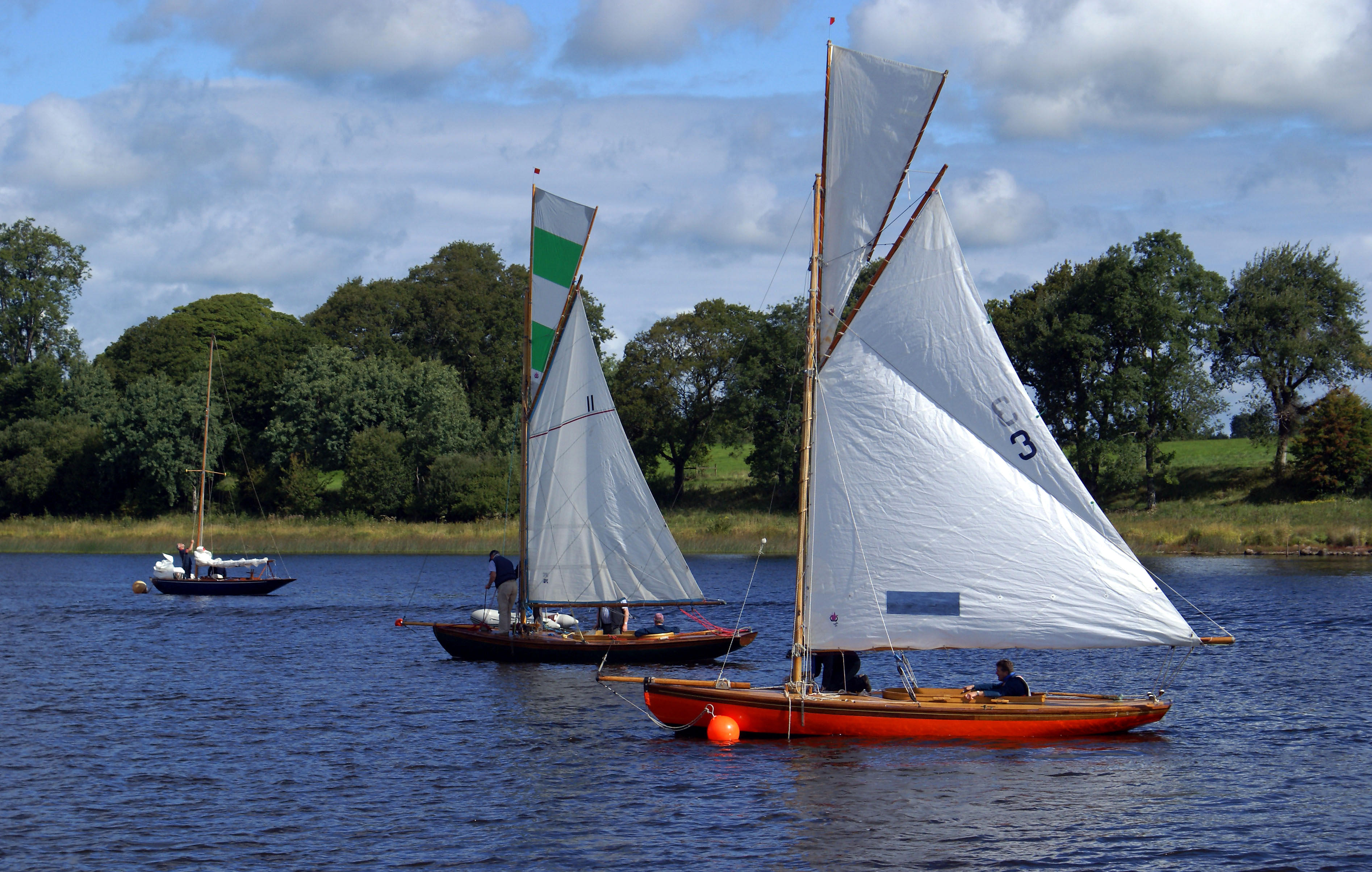 KDNDXB Three classic yachts, including Leila (3) and Deilginis (11) moored with crews preparing to race in regatta on Lough Erne, Co. Fermanagh in 2010