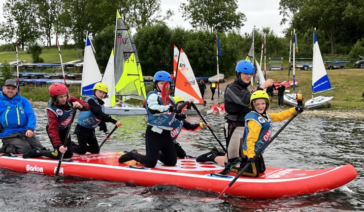 OnBoard fleet having great fun on a giant paddleboard at the British Youth Sailing Regional Junior Championships 2022, Draycote Water SC.