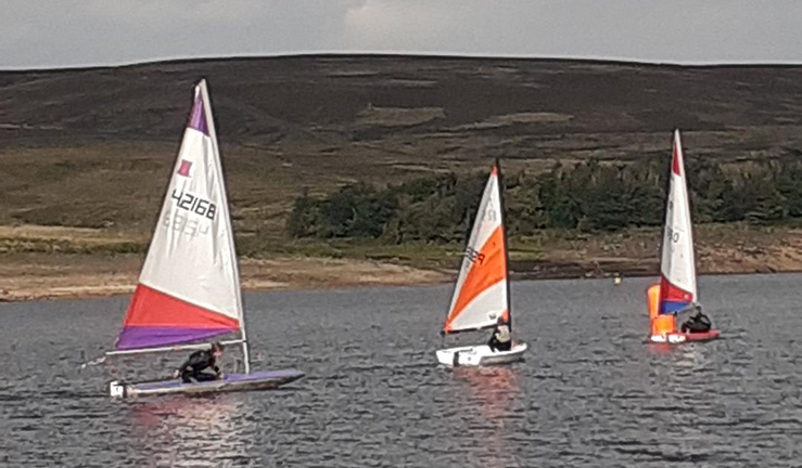 Junior sailor Lucy on the water in her purple Topper at her first NEYYTS race in September 2021 at Yorkshire Dales SC.