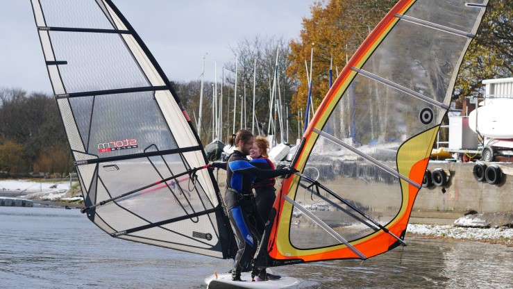 Two windsurfers at Midland SC making a butterfly shape with their sails!