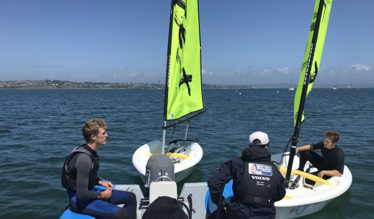 Sailor to Coach camp Summer 2022 (L-R) Alex, Micky and Andy on the water as part of the RYA Race Coach Level 2 course.