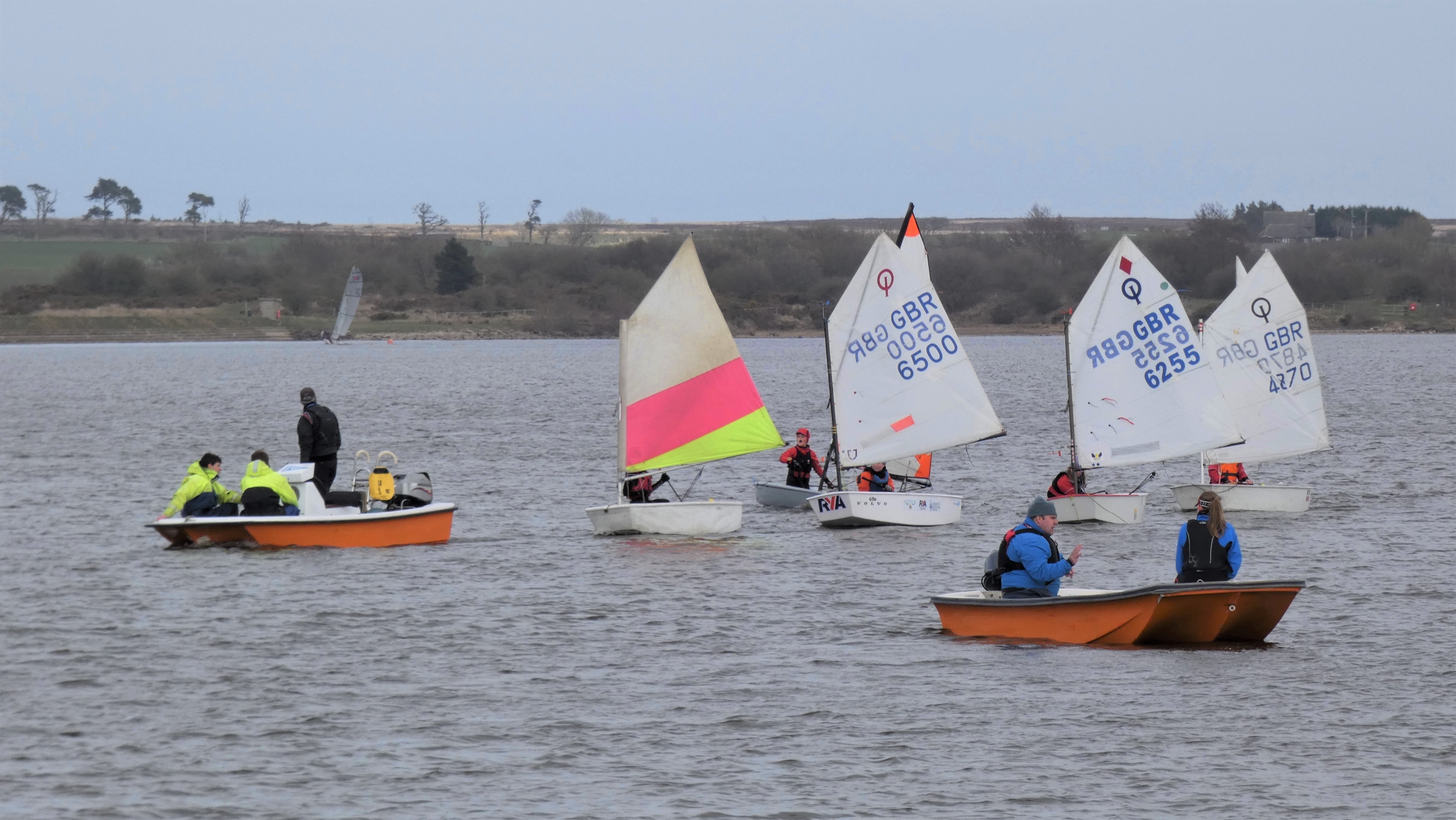 Instructors on the water with junior sailors at Scaling Dam SC in North Yorkshire