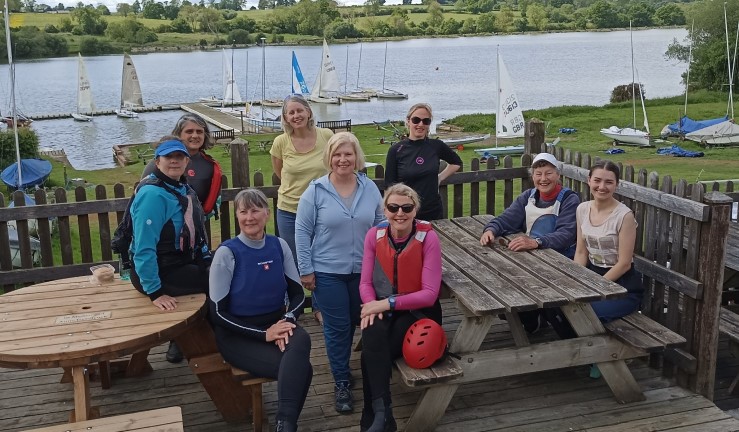 Members of the Women on Water group at Banbury SC on the patio overlooking the water celebrating Steering the Course