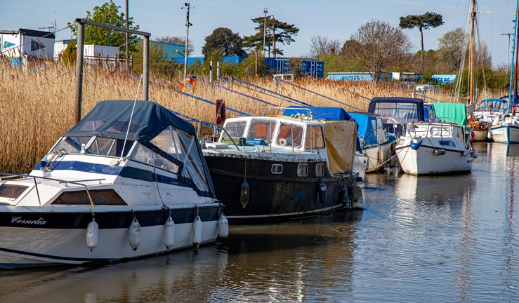 Boats moored up on riverbank 