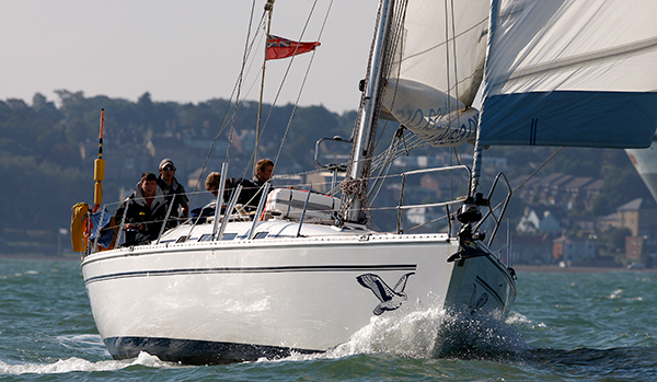 Yacht with reefed sail and yacht with reefed sail with topping lift