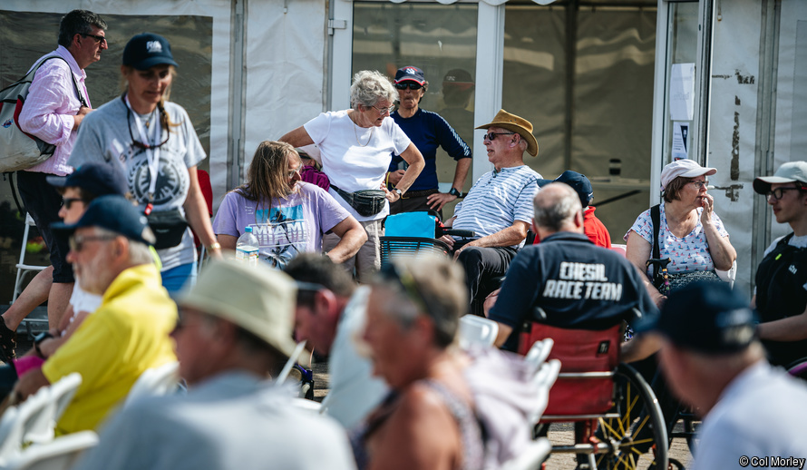 competitors and volunteers waiting for a briefing at the annual Multiclass, a regatta for disabled sailors