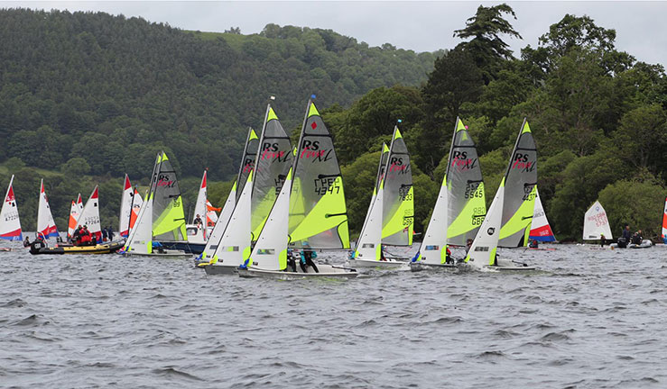 Wides shot of a dozen racing crafts on the lake 