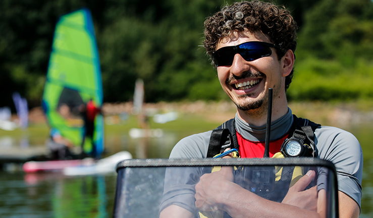 An instructor on the water with a radio