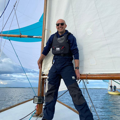 Man standing on top of a yacht 