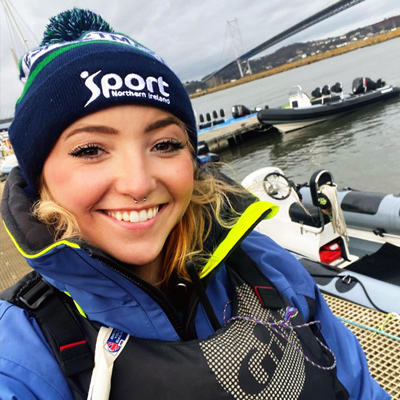 Lady on a pontoon wit her rib with a woolly hat on