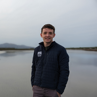 Peter standing on the shore looking over a lake