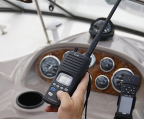 An image showing a VHF radio being held in a hand.