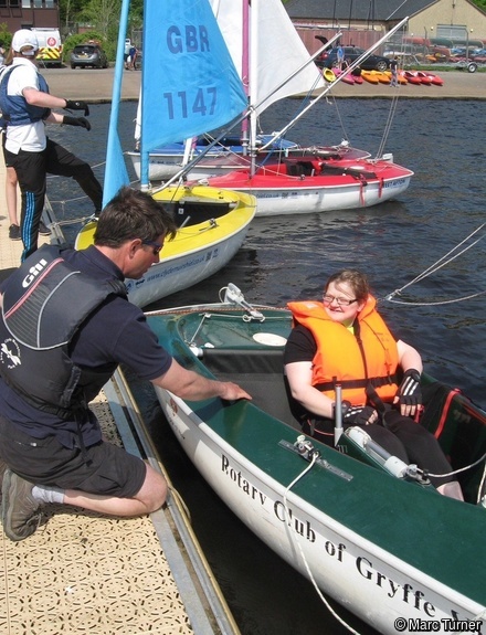 An instructor helping a participant in a Hansa Access Dinghy