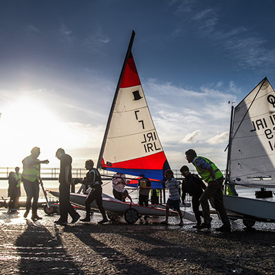 volunteers helping to pull dinghies onshore