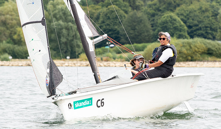 mid shot of a sailor/sailors on a lake