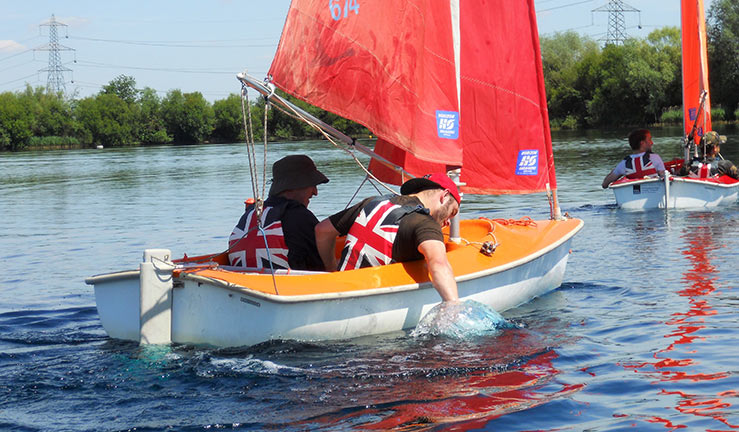 mid shot of a sailor/sailors on a lake