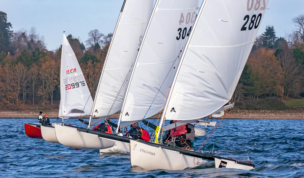 Multiple dinghies in bright blue water