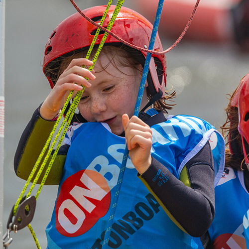 a closeup of a small child pulling rigging