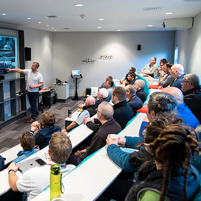 Attendees listening with rapt attention about sailing and training