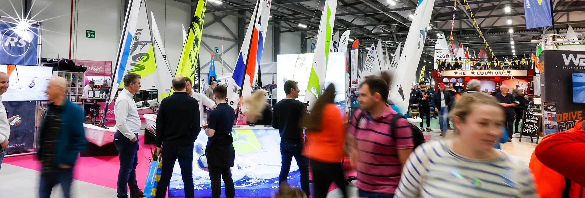 People walking round dinghy and water sports exhibitor show at Farnborough 2023