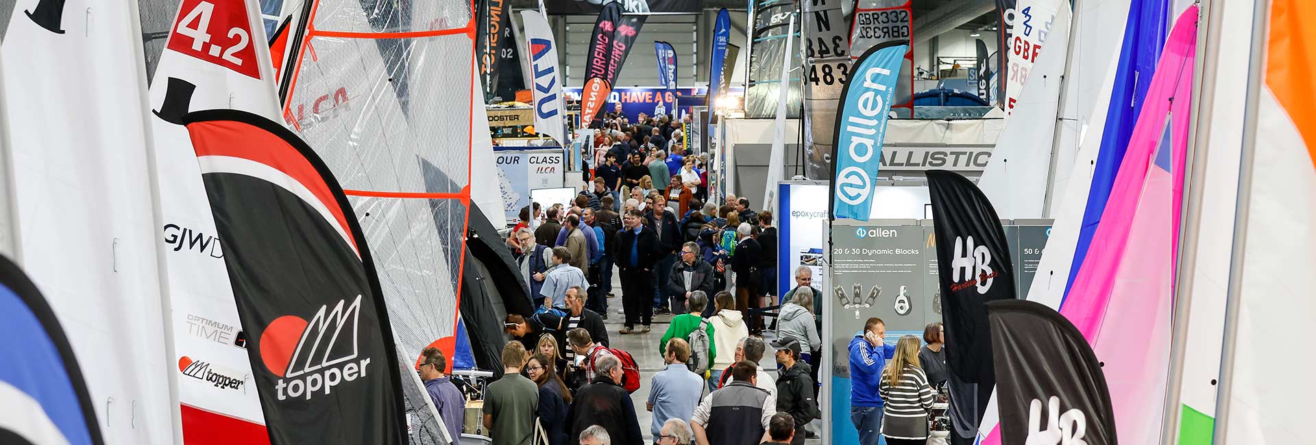 People walking round dinghy and water sports exhibitor show at Farnborough 2023
