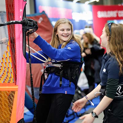 young girl using the wind surfing simulator