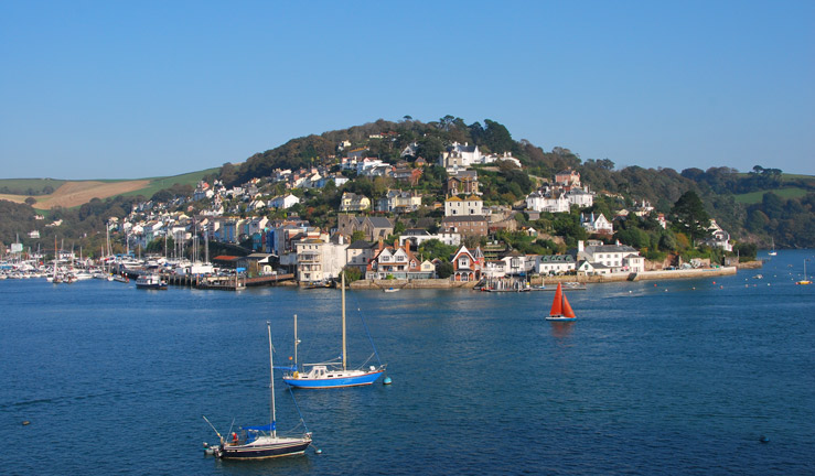 Wide shot of boats sailing by dartmouth harbour