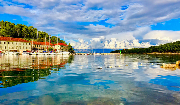 wide shot of a pretty Mediterranean town next to the water