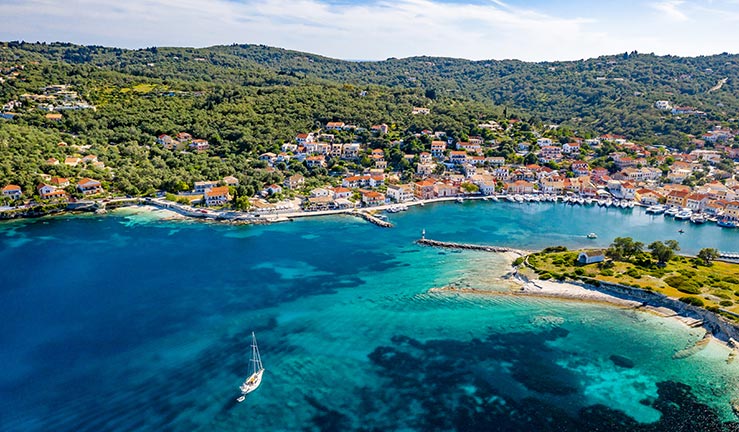 geographical shot of a boat in a cove in a Mediterranean country 