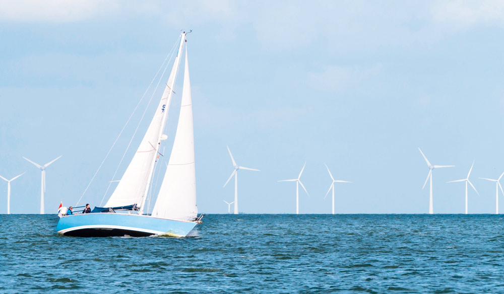 Sailing yacht navigating wind farm