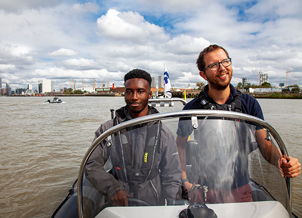candid shot of two young people in a motor boat