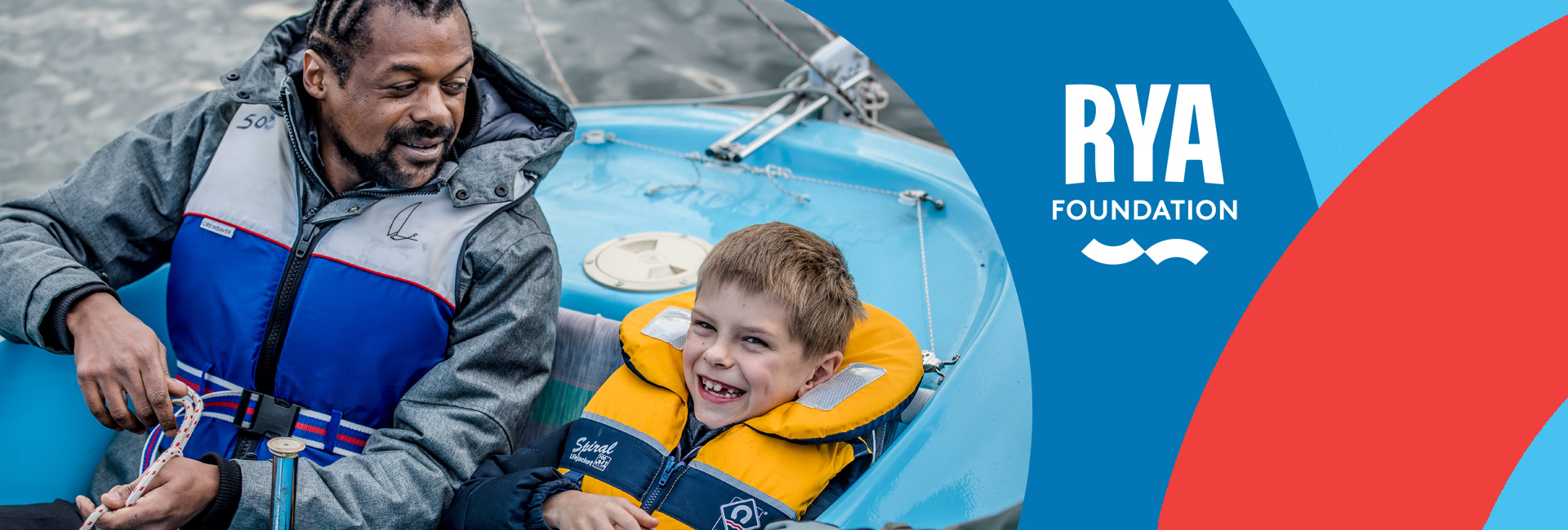 RYA foundation hero with logo and image of young boy and man smiling in sailing dinghy.
