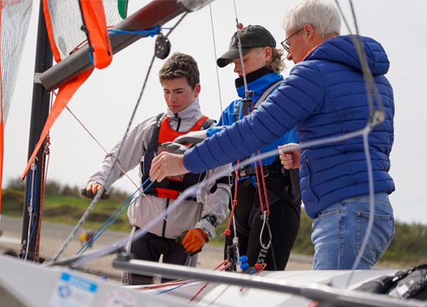 People doing safety checks on a dinghy