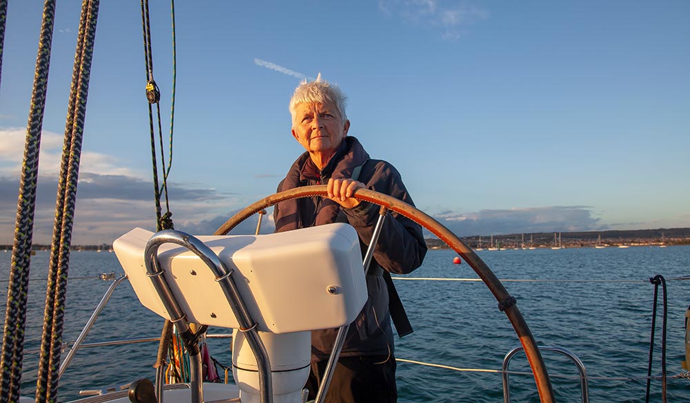 wide shot of woman steering boat