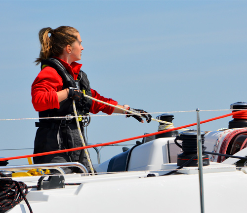 Person pulling a rope on the boat