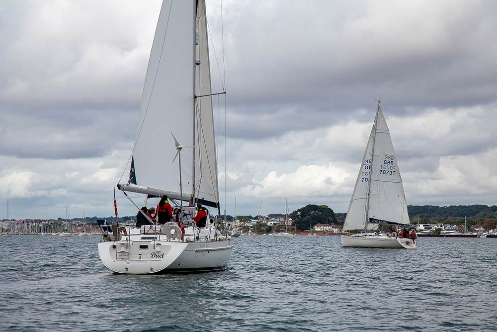 wide shot of two yachts sailing in the distance