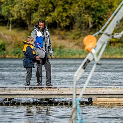 two people walking on a dock