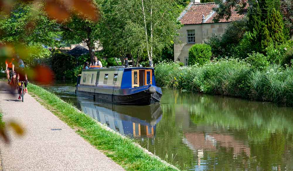 wide shot of canal boat on the water