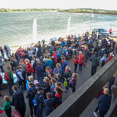 wide shot of a large crowd at a private function outside a sailing club