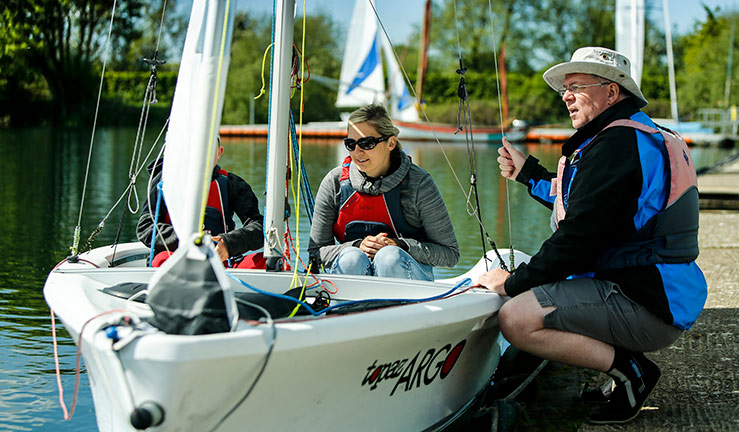 2 people being given pointers on their sailing