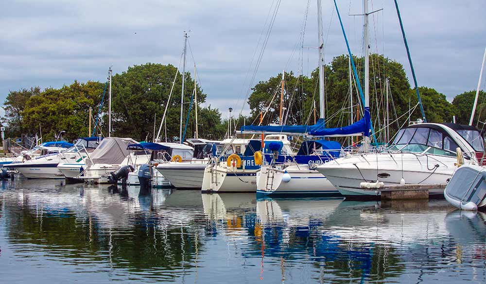 mid shot sailing boats moored on lake