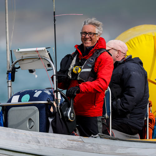 smiling race official on a powerboat