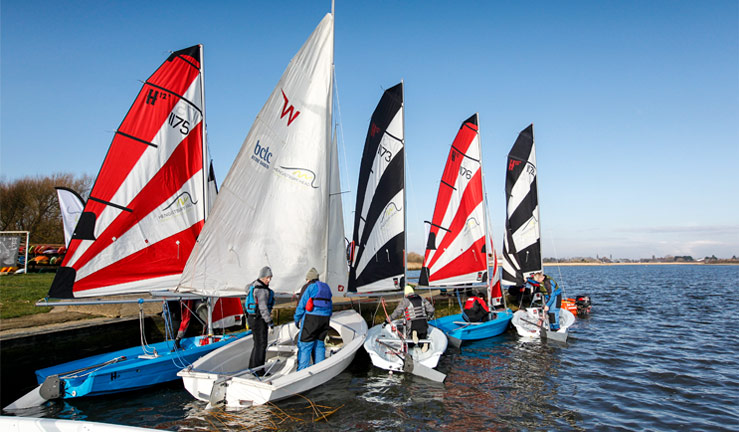 sailors preparing to depart on their dinghys to go sailing