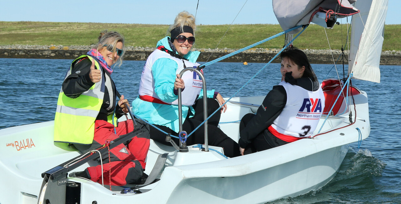 women sailing on dinghy