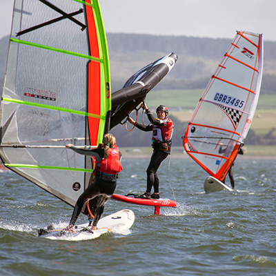 mid shot of racing wind surfers
