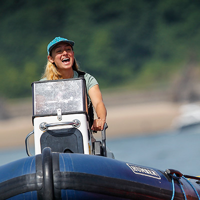 mid shot a of a smiling volunteer on a motorised rib
