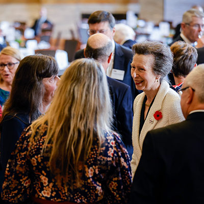 candid shot of volunteers talking to princess Anne at the volunteer awards