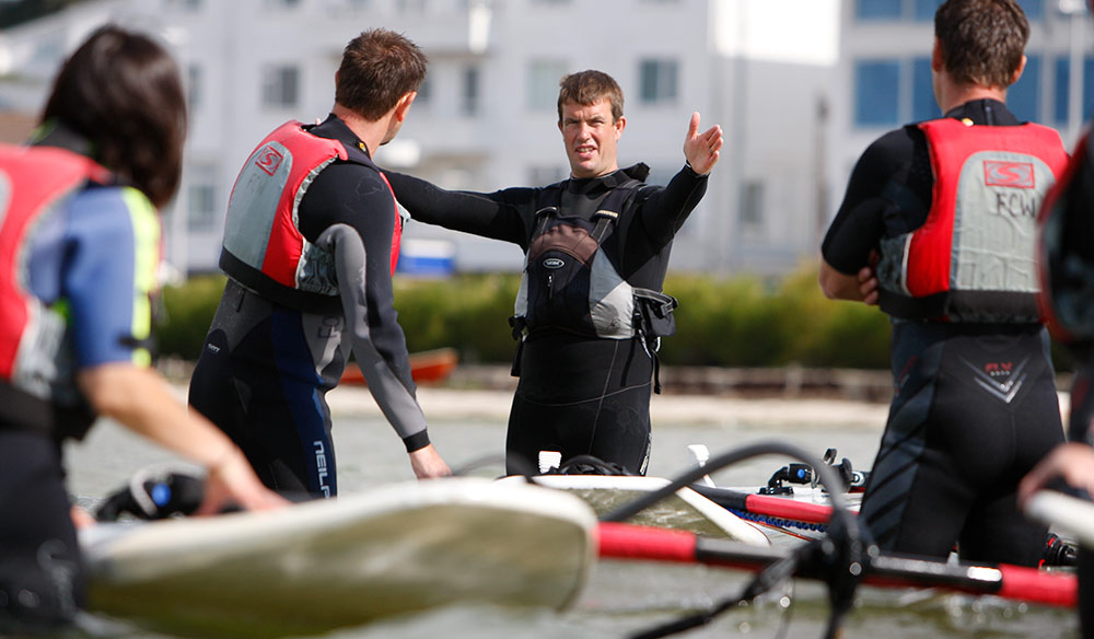 instructor talking to students about windsurfing