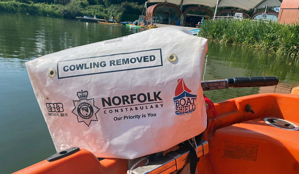 close up of motor boat with security measure in place, says 'cowling removed'